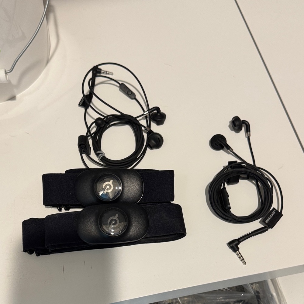 2 Peloton heart rate bands and 2 Peloton Earbuds. 1 of each used once